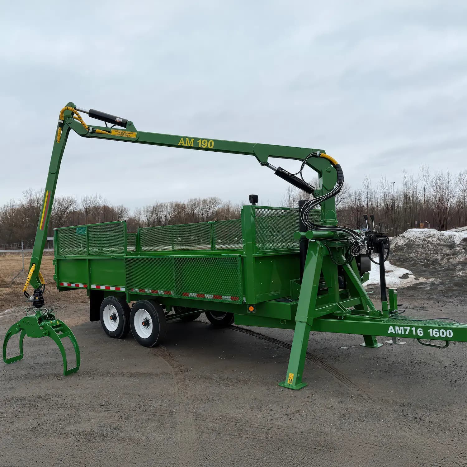 AM 716 1600 self-loading dump trailer with the AM-190 grapple loader fully extended