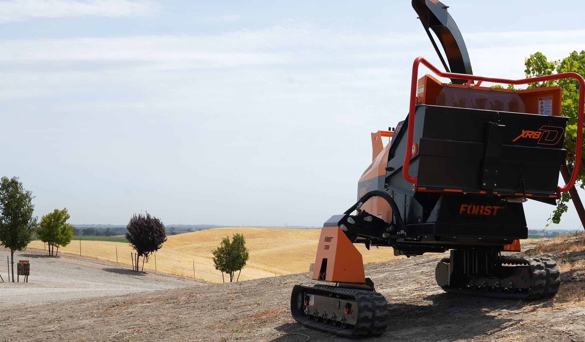 Först XR8D tracked wood chipper on a slope with its Traxion legs at different heights